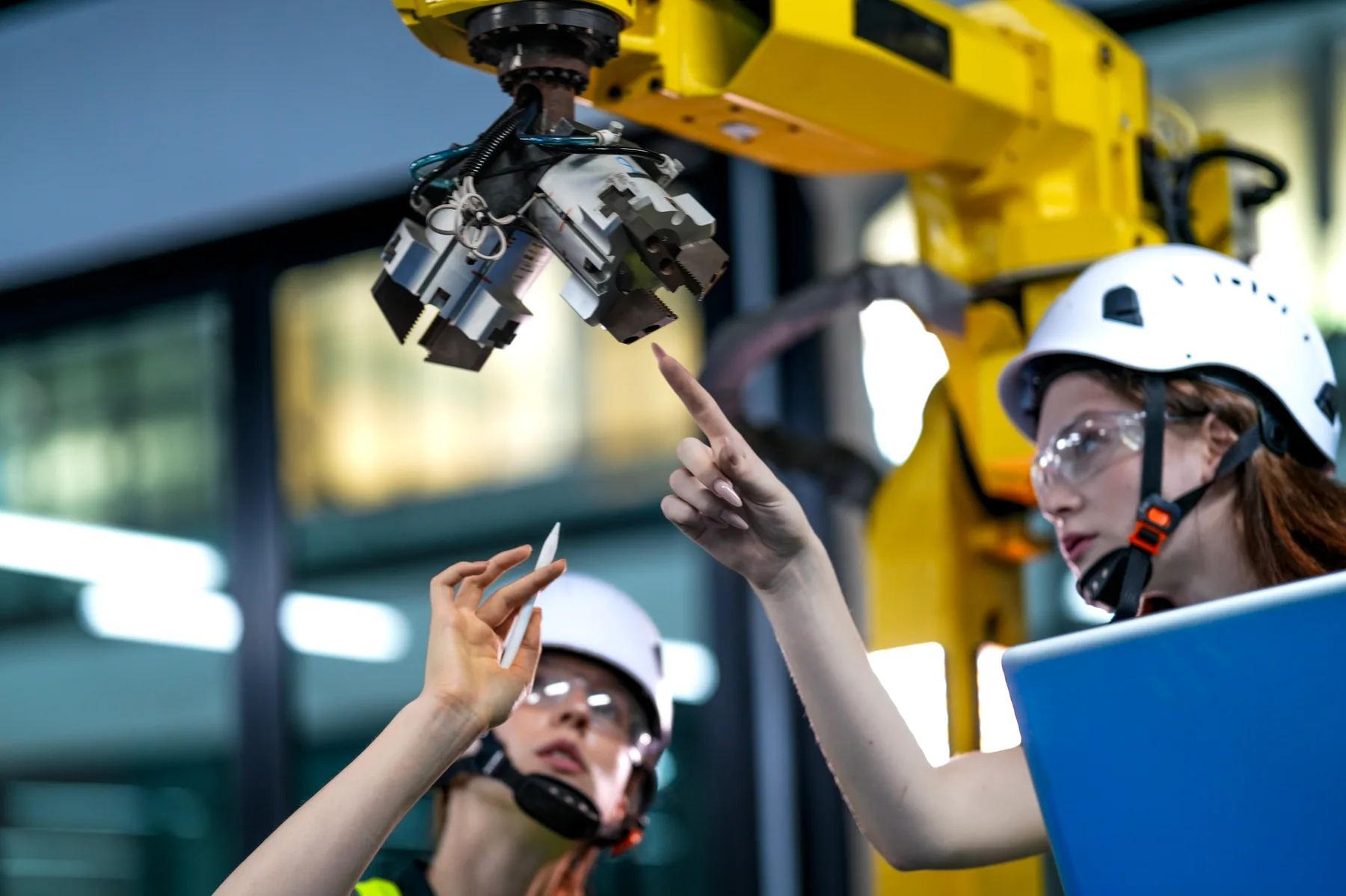 Industrial specialist using AI-assisted inspection workflows with safety gear and digital validation context