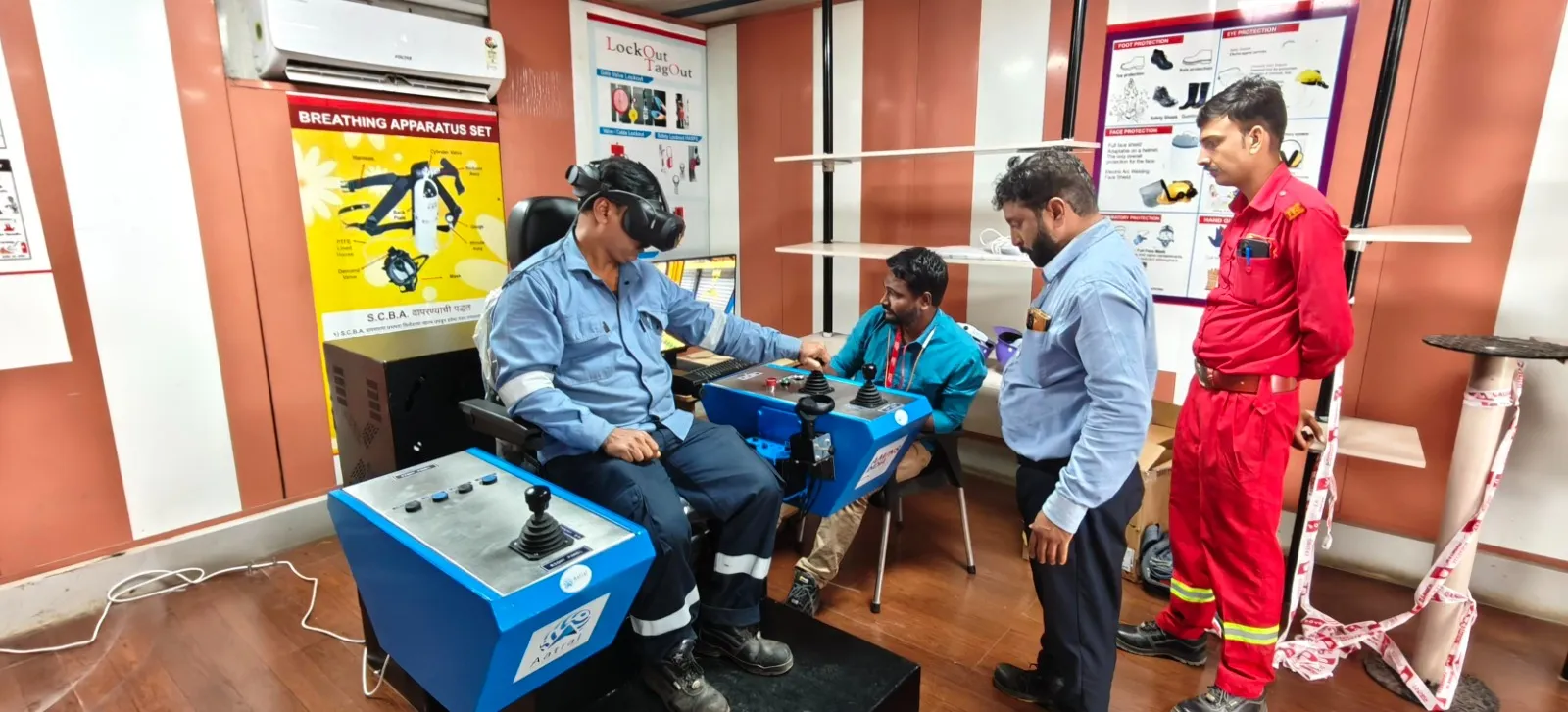 Operator practising on the Arise Crane Simulator with twin joystick consoles at an industrial safety training centre